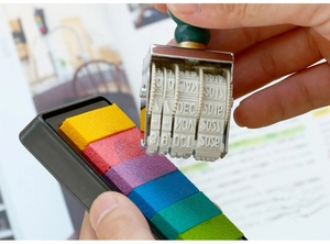 Detail of vintage date roller stamp with a colorful 6-color ink pad set for DIY journaling