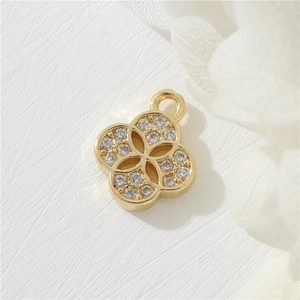 Macro view of a 14K gold-plated clover pendant with sparkling micro-pave cubic zirconia