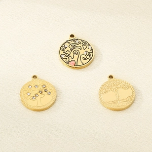 Three gold Tree of Life pendants featuring rhinestones, enamel heart, and embossed metal finish