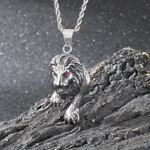 Punk silver stainless steel lion pendant with red gem eyes on twist chain over rock