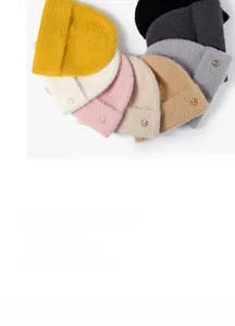 Close-up of thick knitted beanies in various colors with round metallic M logos