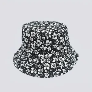 Detailed view of black bucket hat with white floral print and durable twill fabric