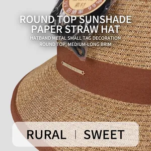 Elegant sun hat with ribbon and metal logo, fine straw texture with sun protection