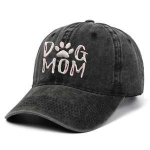 Detailed view of the DOG MOM pink embroidery on a black washed cotton baseball cap