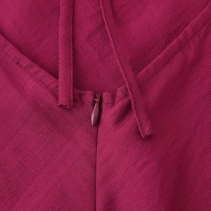 Elegant burgundy halter maxi dress featuring fine linen texture and invisible back zipper
