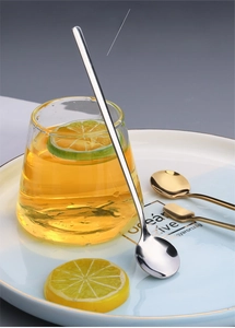 Close-up of long handle 410 stainless steel mixing spoon on lemon tea glass