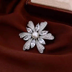Elegant flower brooch with central pearl and marquise zircon petals in silver finish