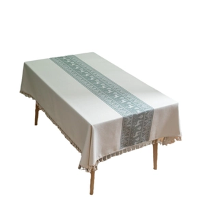 Jacquard Christmas reindeer tablecloth with decorative tassels on a white background