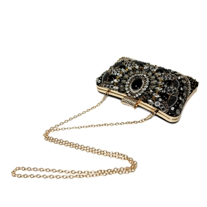 Detailed view of the beaded evening clutch featuring luxury rhinestones and gold metal chain