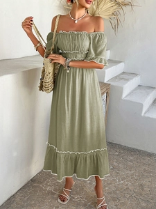 Detail of sage green off-shoulder bohemian dress with white ruffled hem and elastic waist