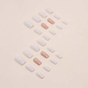 Square press-on nails in cream white and nude pink with subtle glitter finish
