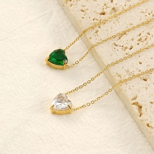 Elegant gold heart pendant necklace with green and clear cubic zirconia in a 4-prong setting
