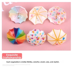 Flat lay of colorful miniature dollhouse umbrella charms for DIY jewelry and crafts