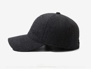 Detailed side view of charcoal grey baseball cap with textured twill fabric and metal accent