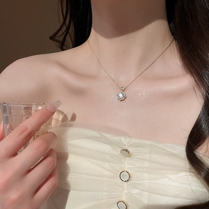 Close-up of 14k gold plated rose pendant necklace featuring a central zircon stone