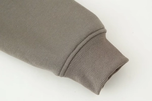 Detailed macro view of dark grey ribbed cuffs and stitching on long sleeve sweatshirt