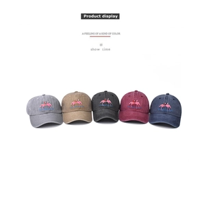 Row of washed cotton baseball caps with flamingo embroidery in five diverse colors