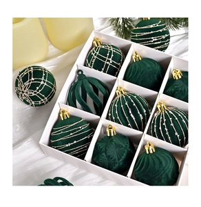 Detail of green velvet Christmas balls with gold glitter patterns in a gift box