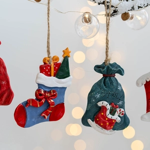 Festive resin Christmas stocking and gift bag ornaments with joyful holiday details