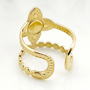 Close-up of gold open ring with blue stone flower and geometric hollow eye design