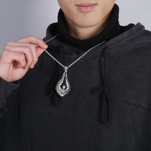Vintage rock style silver angel wings necklace with skull pendant worn on a model