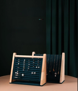 Detail showing high-quality dark green velvet and light wood jewelry display stand set