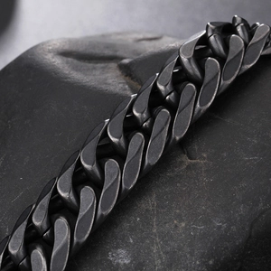 Matte black stainless steel Cuban chain bracelet on black stone for men's fashion jewelry