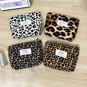 Flat lay of vintage leopard print corduroy makeup pouches in four different colors