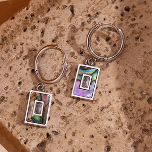 Macro view of stainless steel earring with rectangle abalone shell and zircon stone