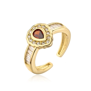 Detailed close-up of a teardrop red zircon ring with 18K gold plating and side stones