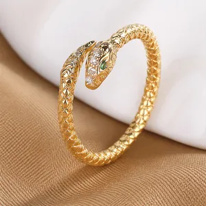 Detailed macro view of a golden S925 silver snake open ring with green crystal eyes