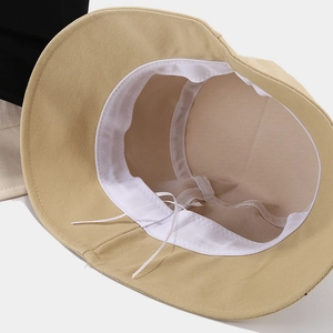 Adjustable beige bucket hat featuring breathable white mesh lining and interior sweatband