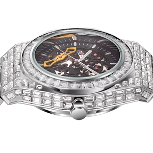 Macro side view of silver luxury fully iced-out watch with skeleton mechanical movement