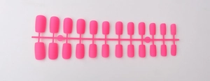 Set of 24 pieces pink matte long square press-on nails arranged on a plastic runner