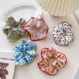 Set of five floral fabric scrunchies in various colors for high elasticity ponytails