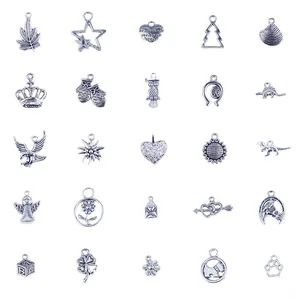 Macro shot of 25 silver antique alloy charms featuring animals and plants for DIY bracelets