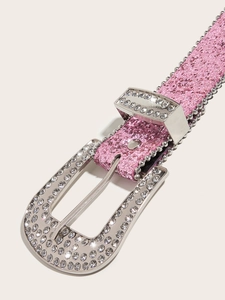 Close-up of pink glitter Y2K belt featuring a large rhinestone horseshoe buckle