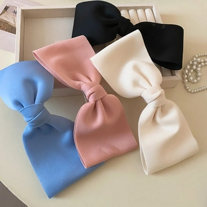 Large fabric bow hair clips set in black, white, pink and blue colors for elegant styling