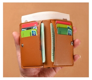 Detailed interior of a slim brown leather wallet showing card slots and transparent ID window