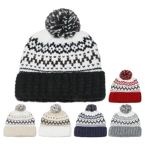 Close-up of Fair Isle geometric jacquard knit pattern and soft pompom on winter hats