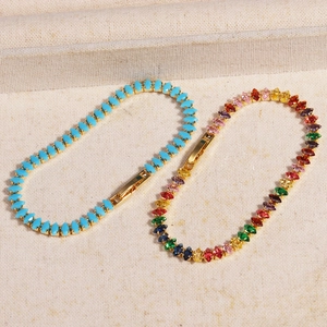 Detailed view of marquise-cut blue and rainbow cubic zirconia tennis bracelets in gold
