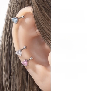 Detailed view of heart-shaped zircon ear cuffs in blue, clear white, and pink finishes