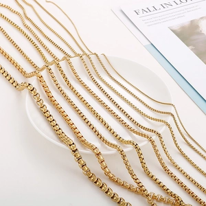 Detail showing various widths of 18K gold plated box chain necklaces in a professional layout
