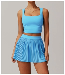 Detail of sky blue sports set featuring a square neck crop top and pleated tennis skirt