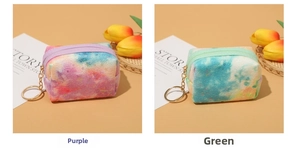 Detail of plush tie-dye star coin purses in purple and green with metal keychains