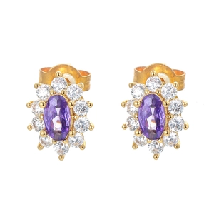 Golden sunburst stud earrings with purple oval gems and white cubic zirconia accents