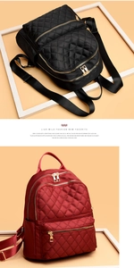Detail of quilted diamond pattern oxford fabric and gold zippers on dual-color backpacks