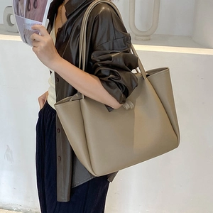 Minimalist large khaki leather tote bag for women showing spacious commuter style