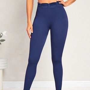 High-waisted seamless dark blue yoga leggings with ruched tummy control waistband