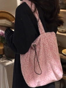 Pink leopard print plush shoulder bag with drawstring closure in soft faux fur material
